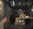 A realistic photo of a curated gift hamper with fresh flowers in the open trunk of a car at a nighttime delivery, illustrating how same-day flower delivery in Lahore actually works.